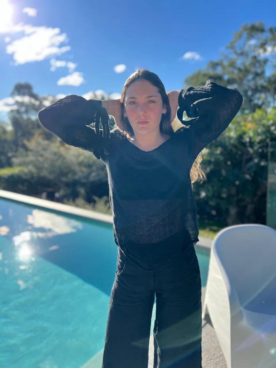 Estilo Emporio Stevie Top - Black worn by model in natural setting LUXAMORE 