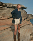 Estilo Emporio Zoe Cashmere - Navy sustainable knit worn by model at the beach LUXAMORE  
