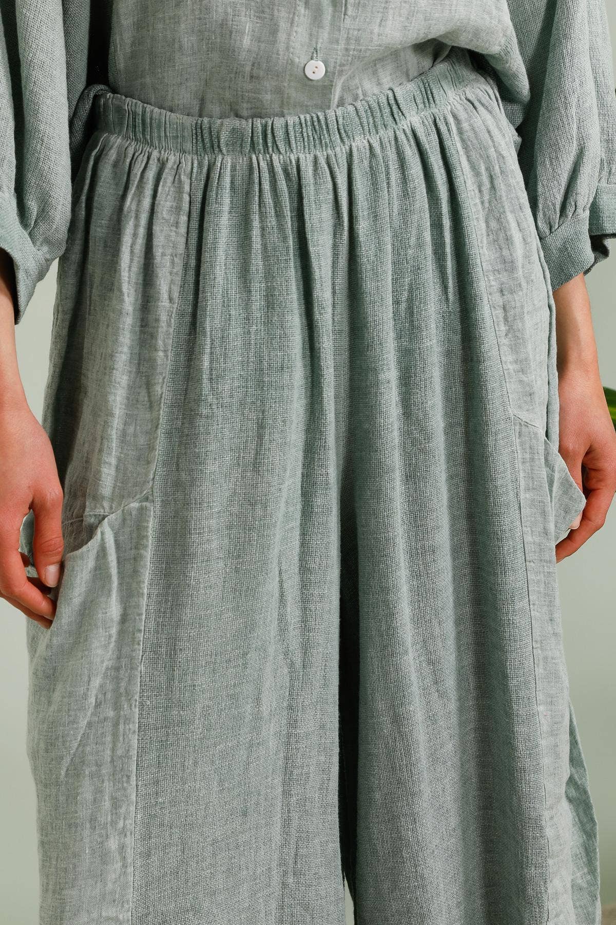 Linen Trousers made in Italy Charcoal Grey worn by model in natural setting LUXAMORE 