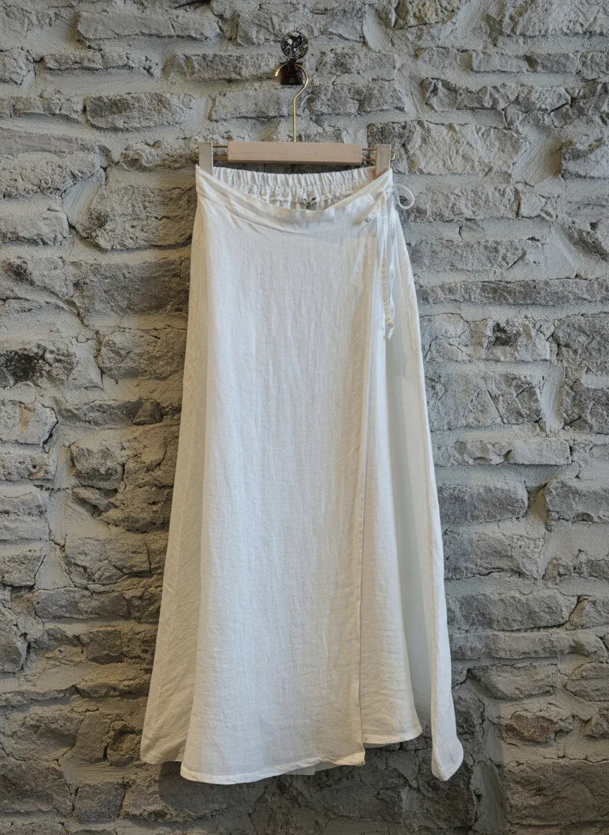 Linen Wrap Skirt With Pockets Made in Italy White worn by model in natural setting LUXAMORE 