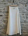 Linen Wrap Skirt With Pockets Made in Italy White worn by model in natural setting LUXAMORE 