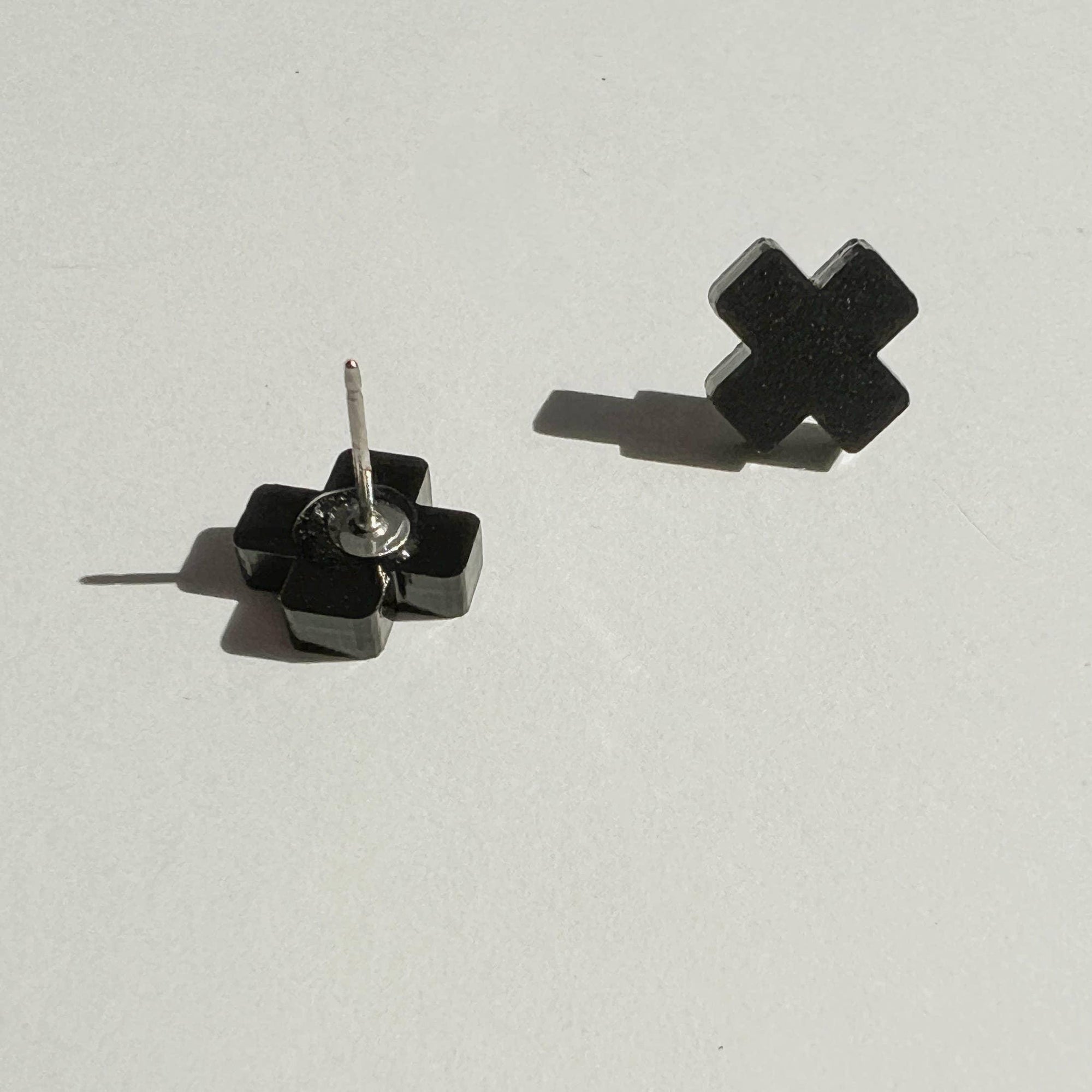 Mingled Black Cross Stud Earrings - Small Cross Earrings, Minimalist worn by model in natural setting LUXAMORE 