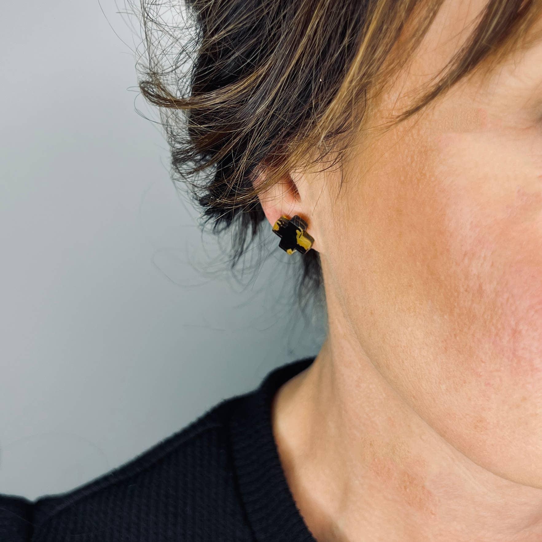 Mingled Black Cross Stud Earrings - Small Cross Earrings, Minimalist worn by model in natural setting LUXAMORE 