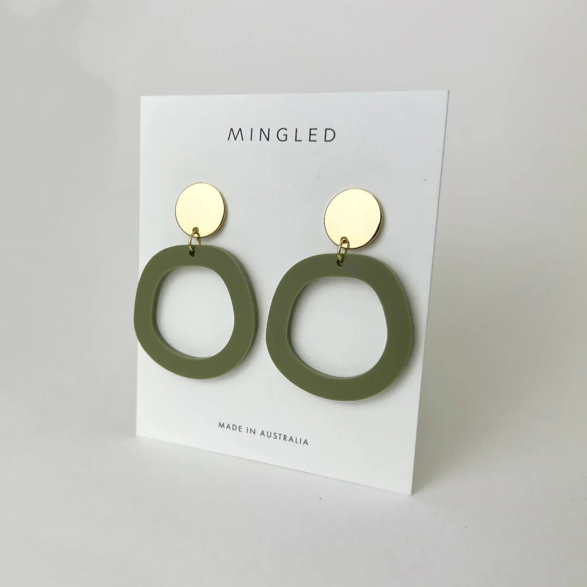 Mingled Charlie Olive Green and Gold Dangle Earrings worn by model in natural setting LUXAMORE 