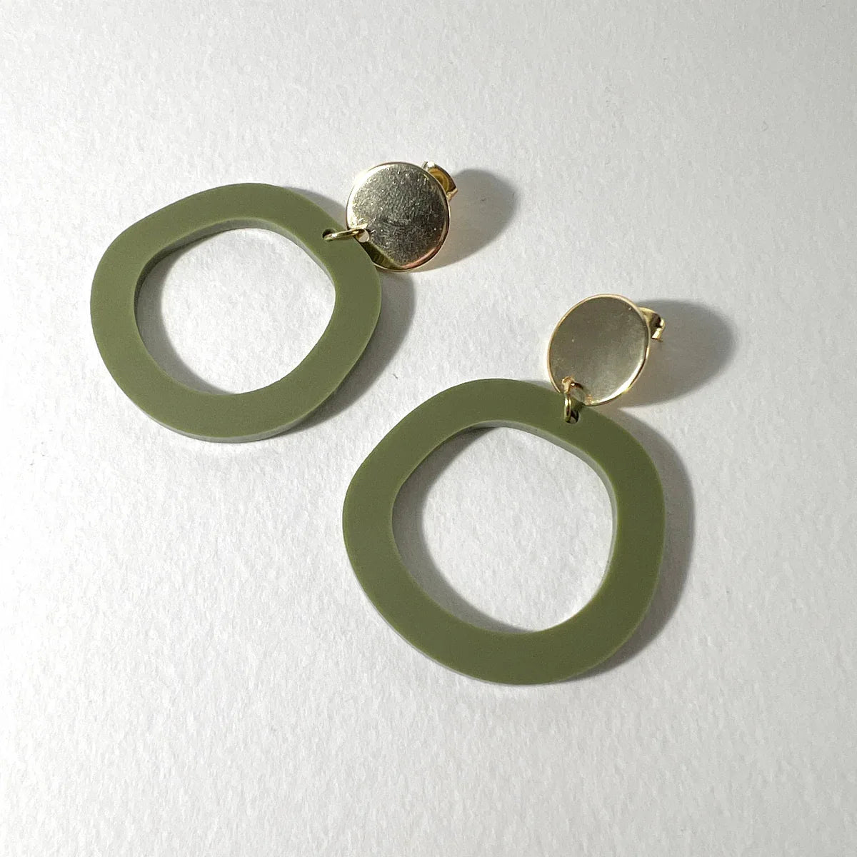 Mingled Charlie Olive Green and Gold Dangle Earrings worn by model in natural setting LUXAMORE 