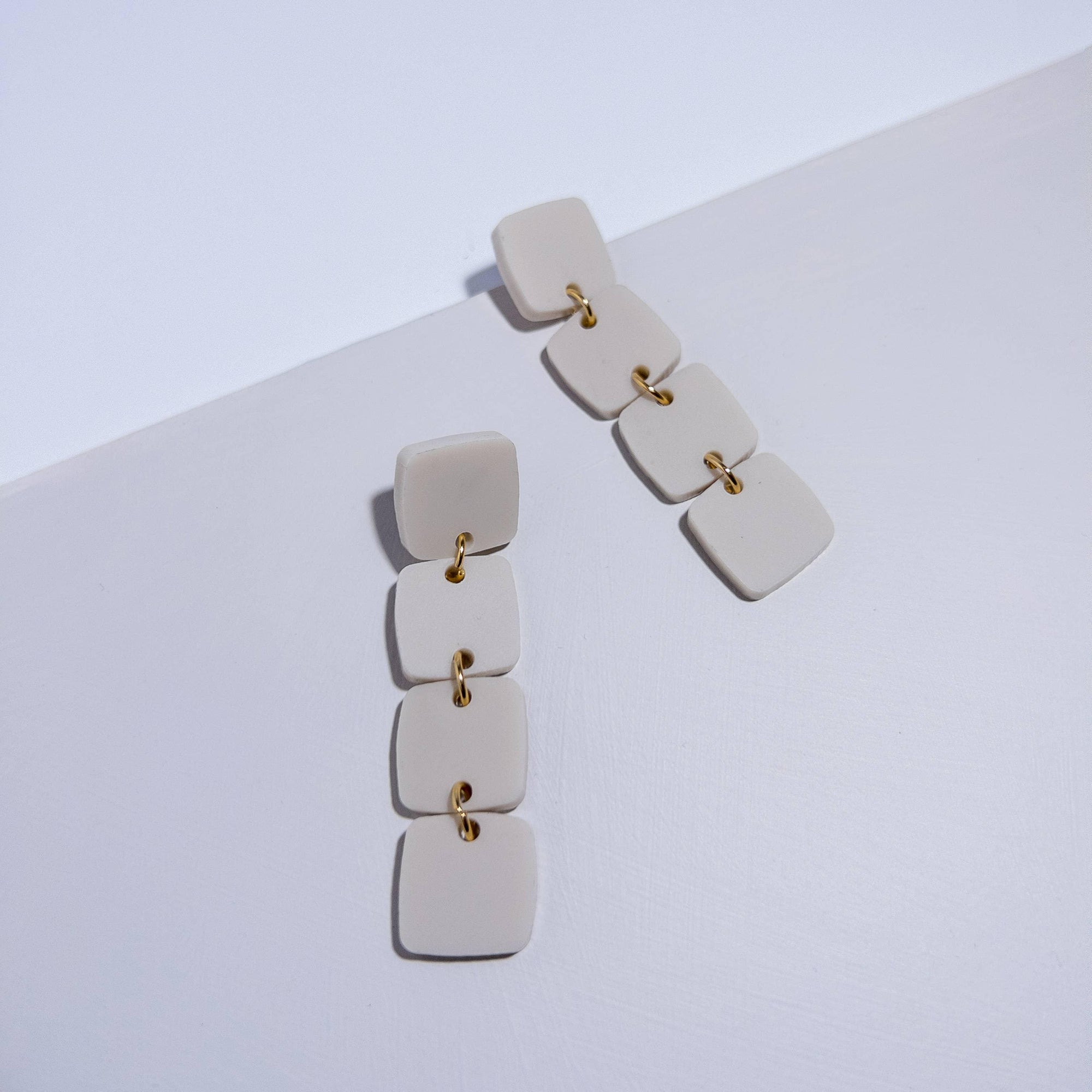 Mingled Dangle Earrings - Ivory Beige Four Squared Long Drop worn by model in natural setting LUXAMORE 