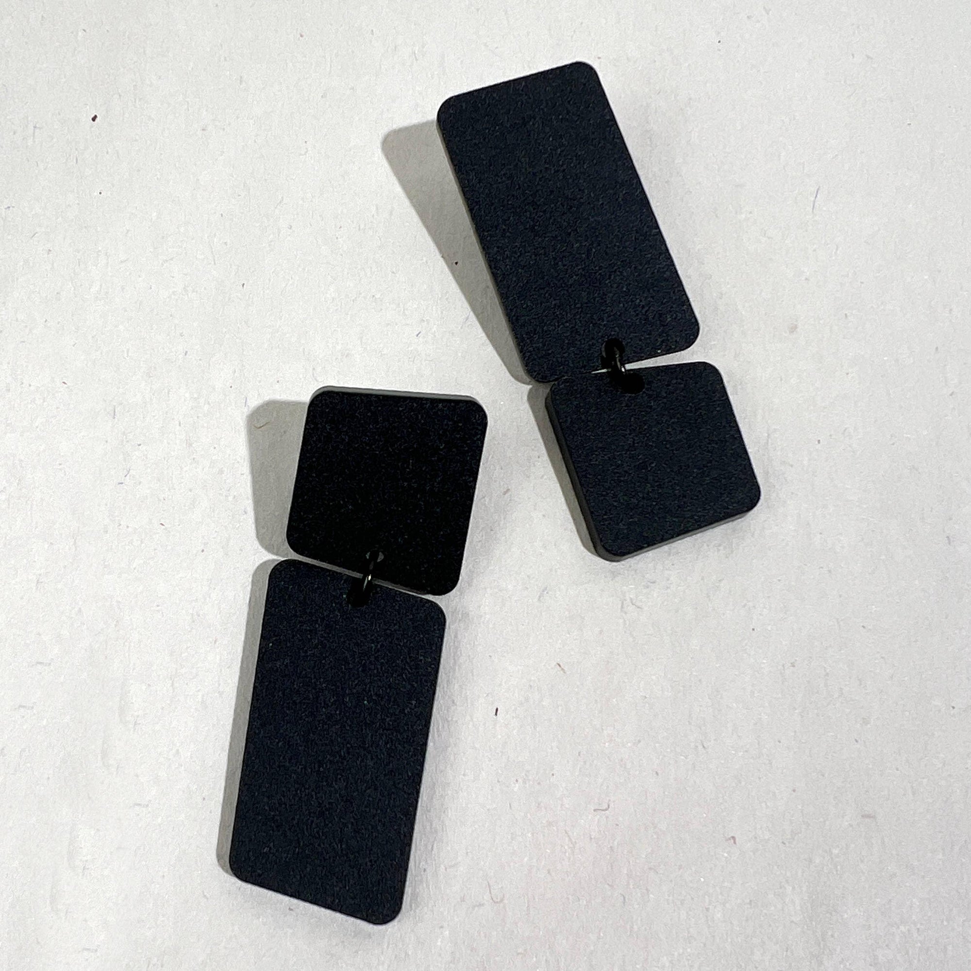 Mingled Dangle Earrings in Black Bauhaus Asymmetrical worn by model in natural setting LUXAMORE 