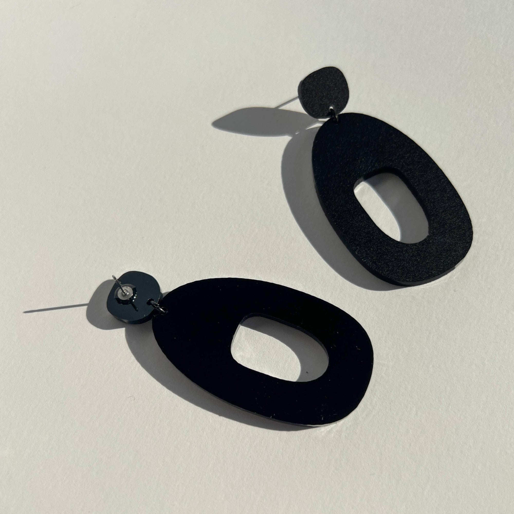 Mingled Soko Large Matte Black Statement Earrings worn by model in natural setting LUXAMORE 