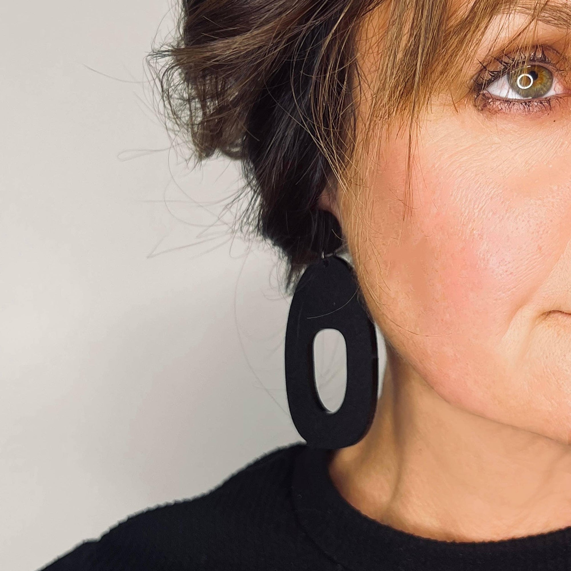 Mingled Soko Large Matte Black Statement Earrings worn by model in natural setting LUXAMORE 