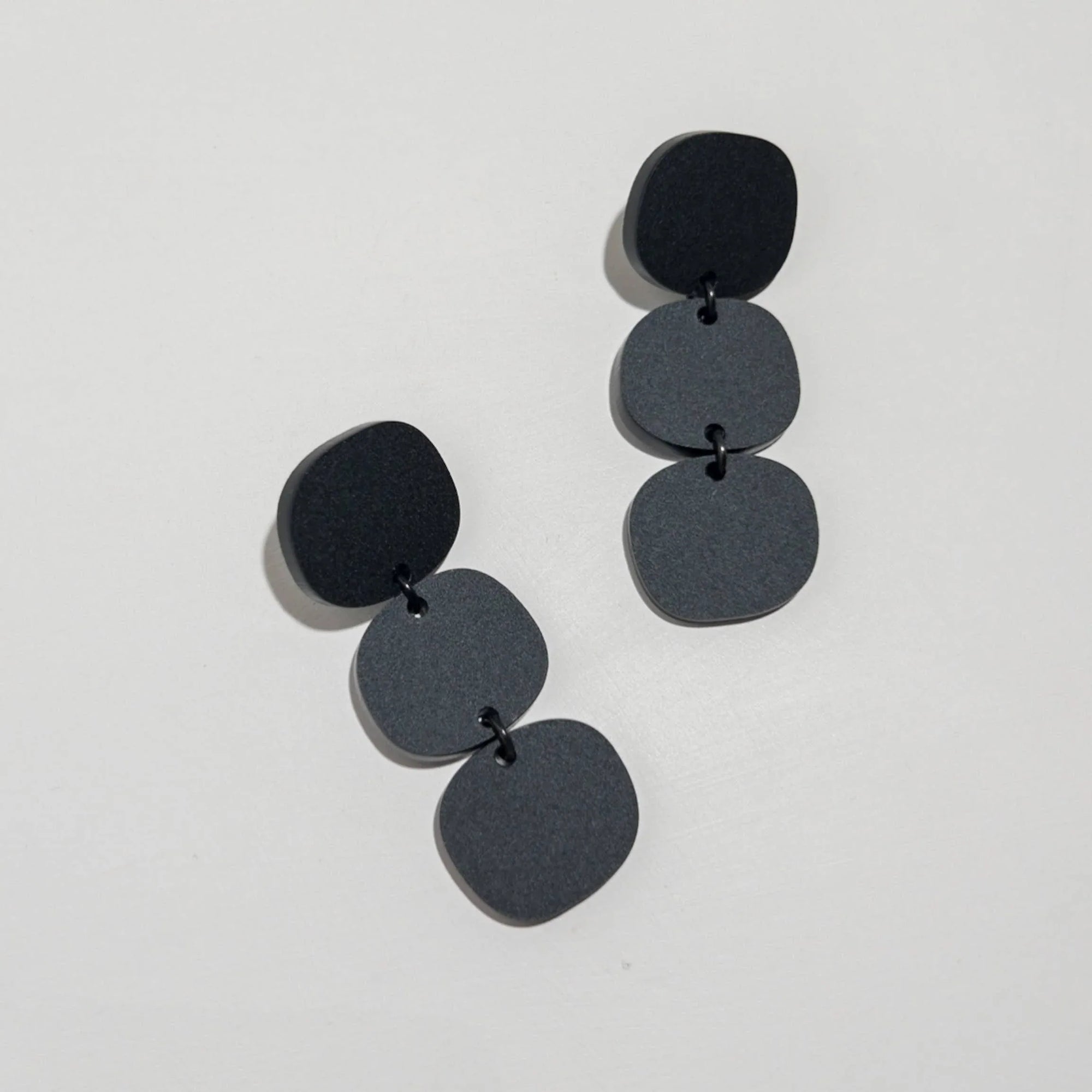 Mingled Statement Earrings - Black Triple Stack worn by model in natural setting LUXAMORE 