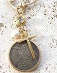 Pre Order Chunky coin necklace cross matte gold jewelry worn by model in natural setting LUXAMORE 